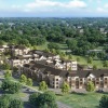 an aerial shot of a building with trees surrounding it